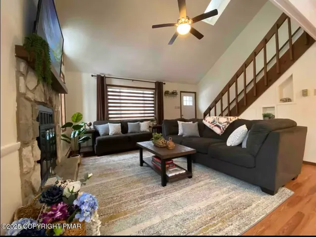 a living room with furniture flowerpot and a window