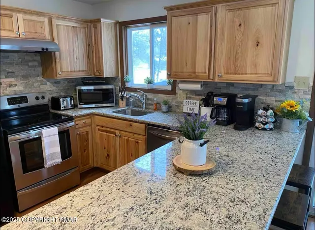 a kitchen with a sink and cabinets