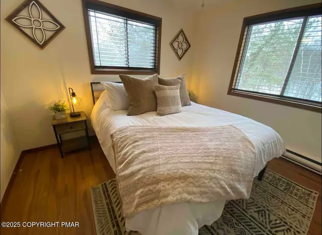 a bed sitting in a bedroom next to a window