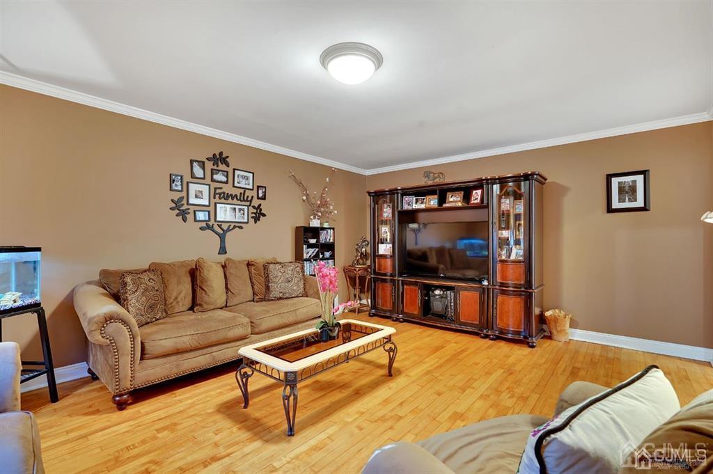 83 Amboy Road Old Bridge, NJ 07747 - Photo 13 of 40 a living room with furniture and a flat screen tv