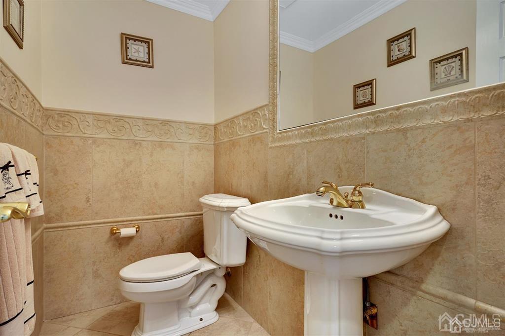 83 Amboy Road Old Bridge, NJ 07747 - Photo 14 of 40 a bathroom with a sink a toilet and mirror