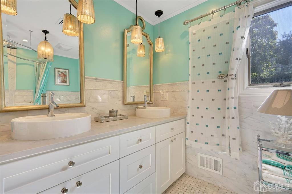 83 Amboy Road Old Bridge, NJ 07747 - Photo 16 of 40 a bathroom with a double vanity sink mirror and shower