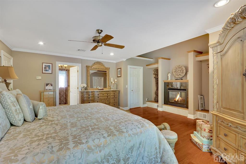 83 Amboy Road Old Bridge, NJ 07747 - Photo 20 of 40 a bedroom with a bed and a chandelier