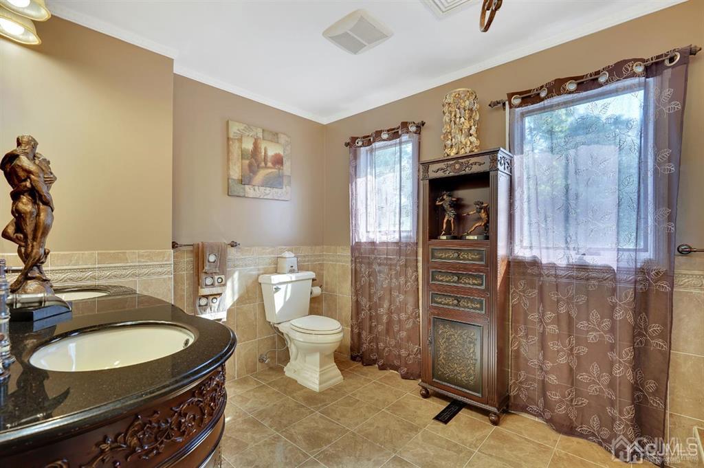 83 Amboy Road Old Bridge, NJ 07747 - Photo 24 of 40 a bathroom with a granite countertop toilet sink and mirror