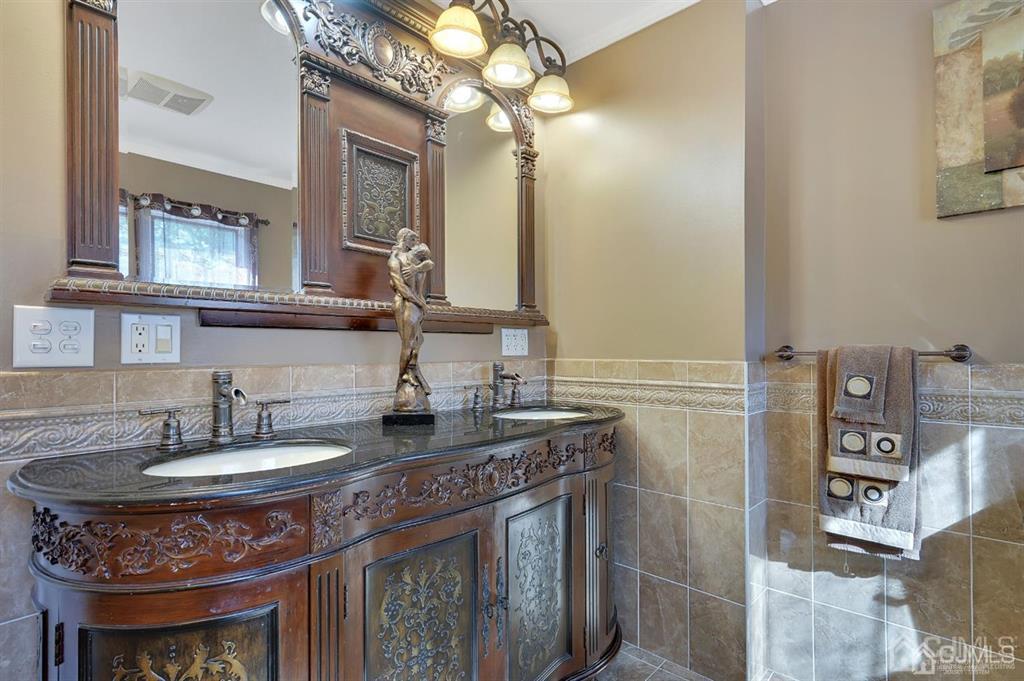 83 Amboy Road Old Bridge, NJ 07747 - Photo 25 of 40 a bathroom with a granite countertop sink a light fixture and a mirror
