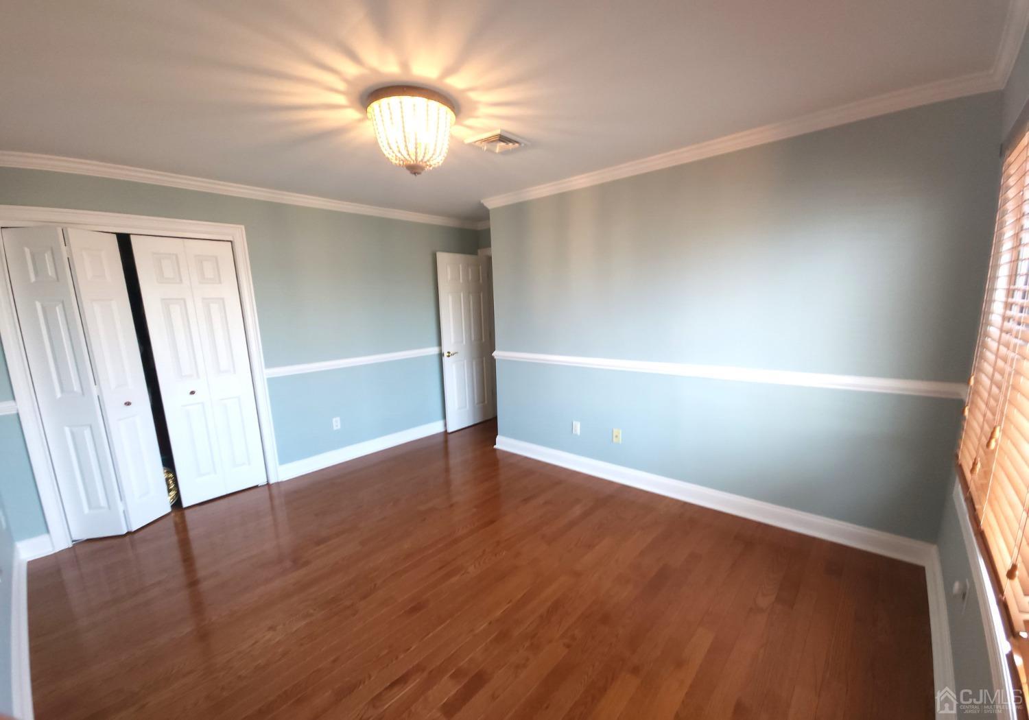 83 Amboy Road Old Bridge, NJ 07747 - Photo 27 of 40 an empty room with wooden floor and window