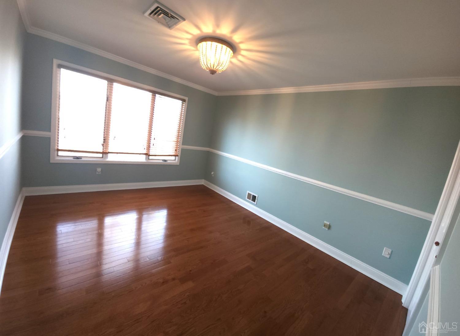 83 Amboy Road Old Bridge, NJ 07747 - Photo 28 of 40 an empty room with wooden floor and windows
