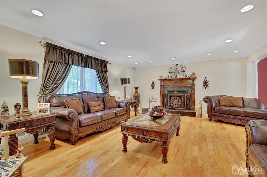 83 Amboy Road Old Bridge, NJ 07747 - Photo 3 of 40 a living room with furniture and a fireplace
