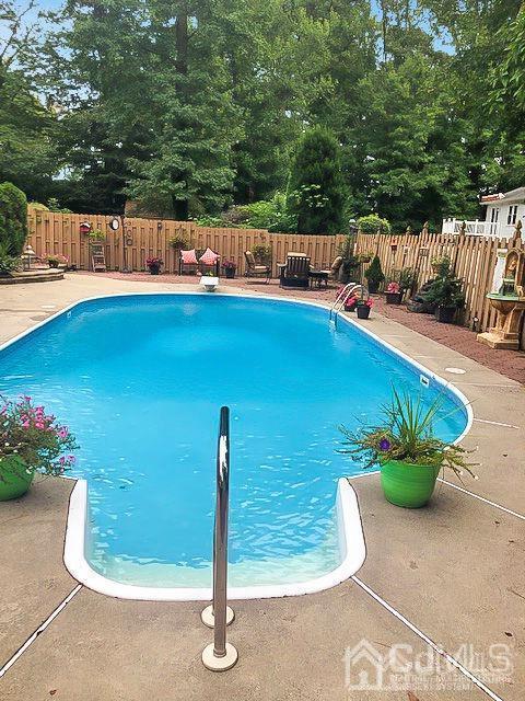 83 Amboy Road Old Bridge, NJ 07747 - Photo 35 of 40 a view of a swimming pool with a patio