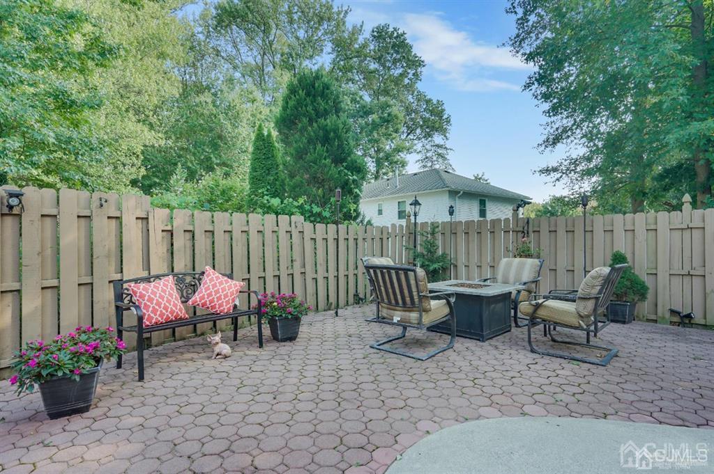 83 Amboy Road Old Bridge, NJ 07747 - Photo 38 of 40 a backyard of a house with dining table and chairs