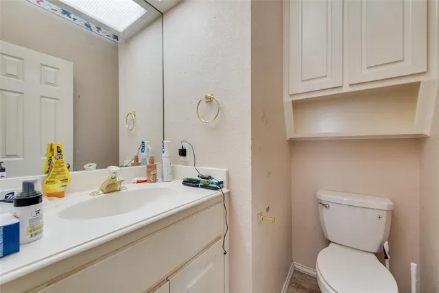 a bathroom with a sink toilet and mirror