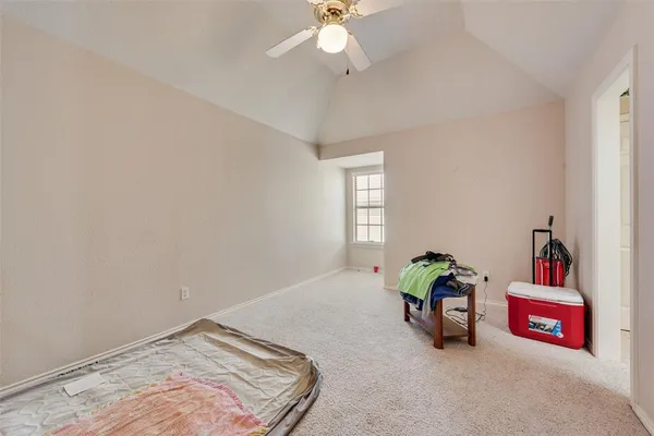 a spacious bedroom with a bed and a chandelier