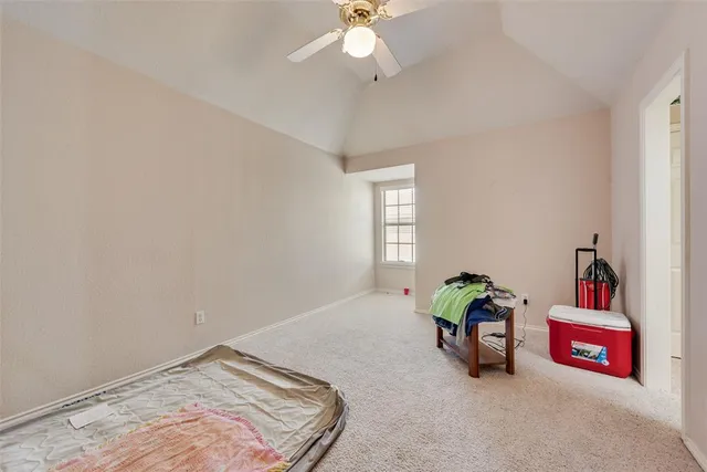 a spacious bedroom with a bed and a chandelier