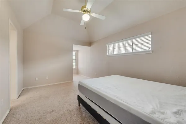 a bedroom with a bed and a ceiling fan