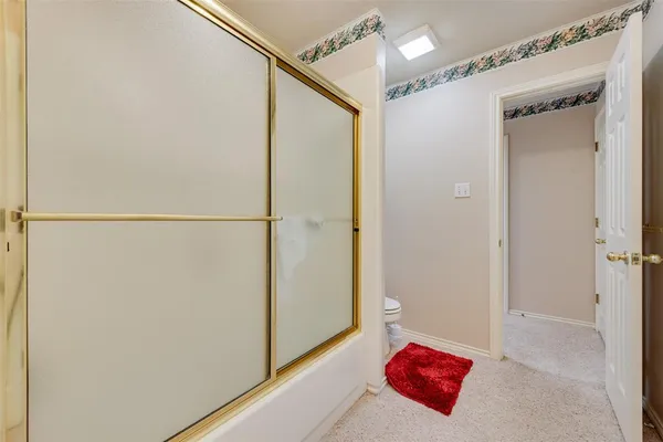 a bathroom with a shower and a sink