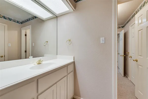 a bathroom with a sink vanity and a mirror