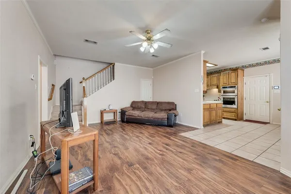 a living room with furniture and kitchen view