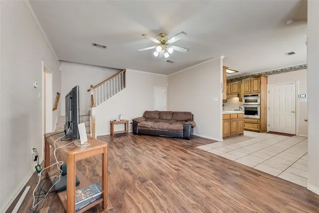 a living room with furniture and kitchen view
