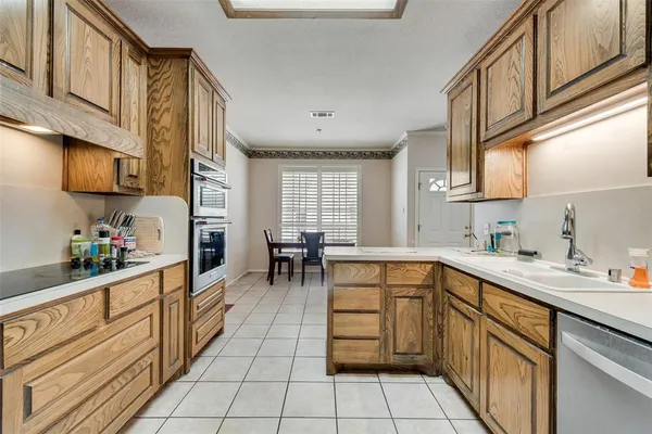 a kitchen with stainless steel appliances a sink window and cabinets