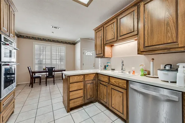 a kitchen with stainless steel appliances granite countertop a sink and cabinets