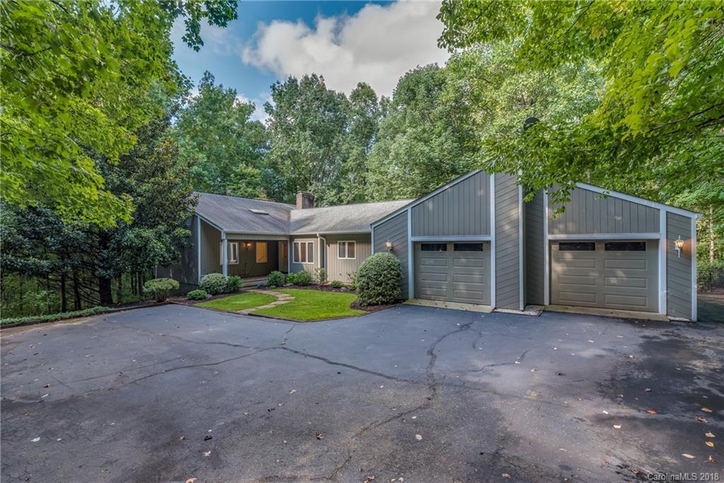 688 Laurel Ridge Road Columbus, NC 28722 - Photo 2 of 30 a front view of a house with a yard and garage
