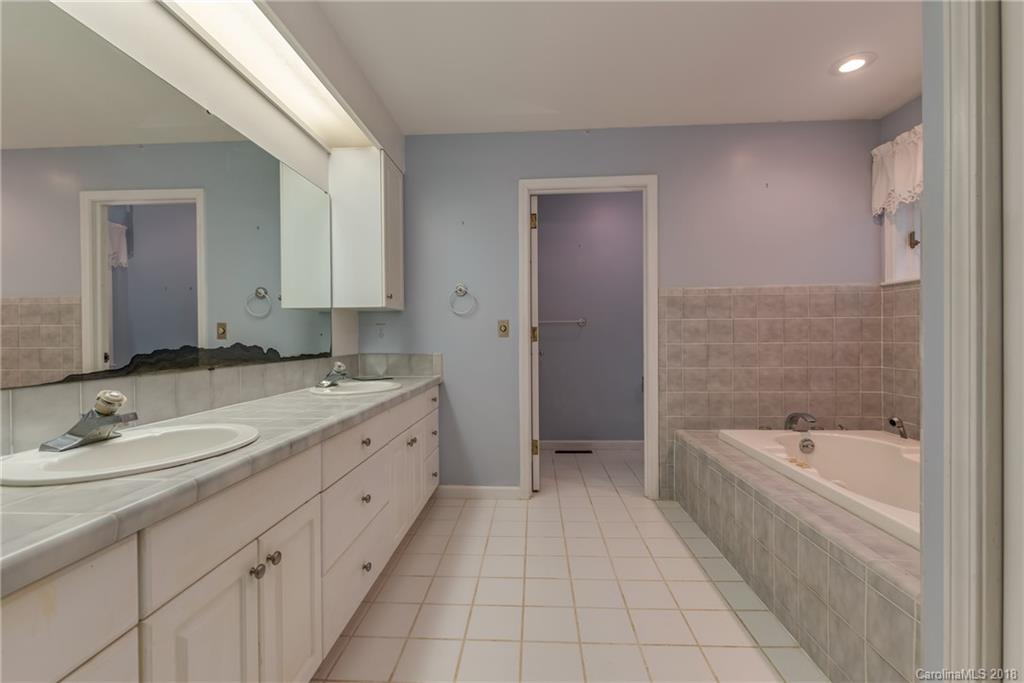 688 Laurel Ridge Road Columbus, NC 28722 - Photo 14 of 30 a spacious bathroom with a tub sink and mirror