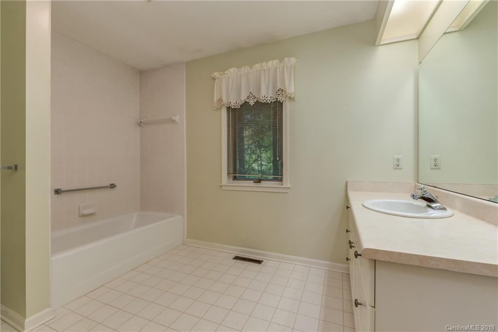 688 Laurel Ridge Road Columbus, NC 28722 - Photo 16 of 30 a bathroom with a bathtub and a sink