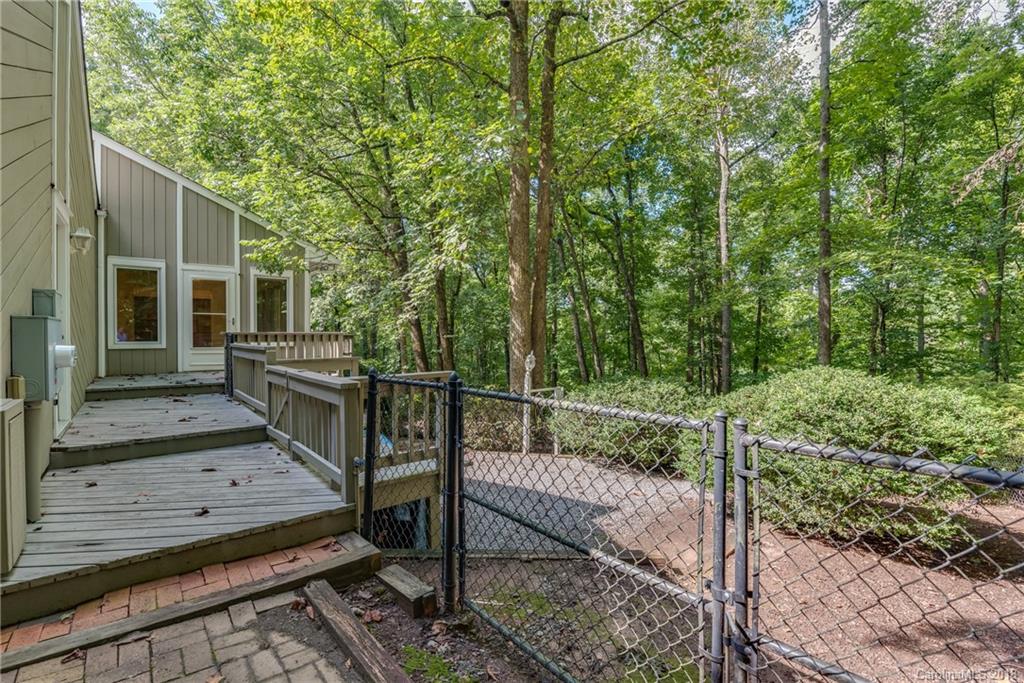 688 Laurel Ridge Road Columbus, NC 28722 - Photo 18 of 30 a view of a wooden deck and a backyard