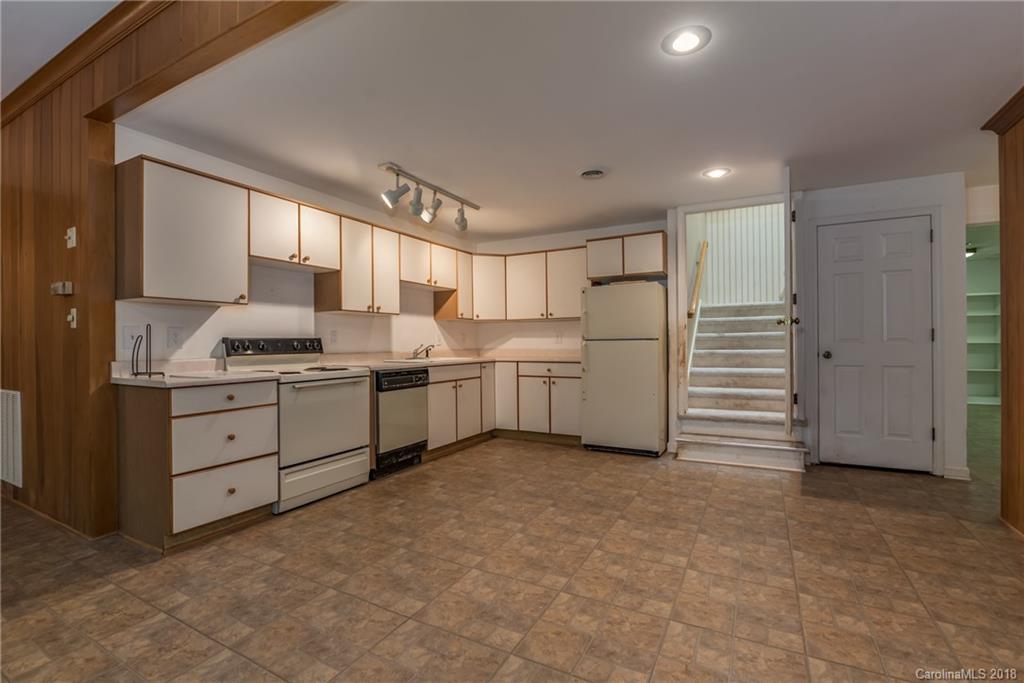 688 Laurel Ridge Road Columbus, NC 28722 - Photo 23 of 30 a kitchen with white cabinets and white appliances