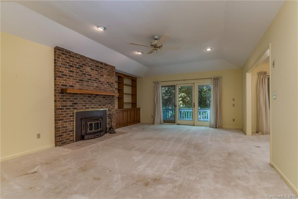 688 Laurel Ridge Road Columbus, NC 28722 - Photo 4 of 30 a view of an empty room with a fireplace and a window