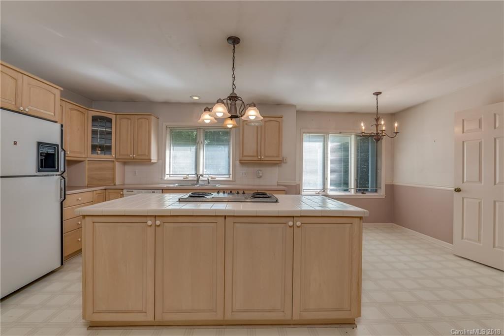 688 Laurel Ridge Road Columbus, NC 28722 - Photo 6 of 30 a kitchen with kitchen island granite countertop a sink and dishwasher
