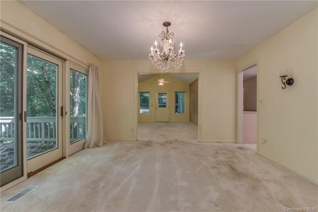 688 Laurel Ridge Road Columbus, NC 28722 - Photo 10 of 30 a view of a big room with windows and chandelier