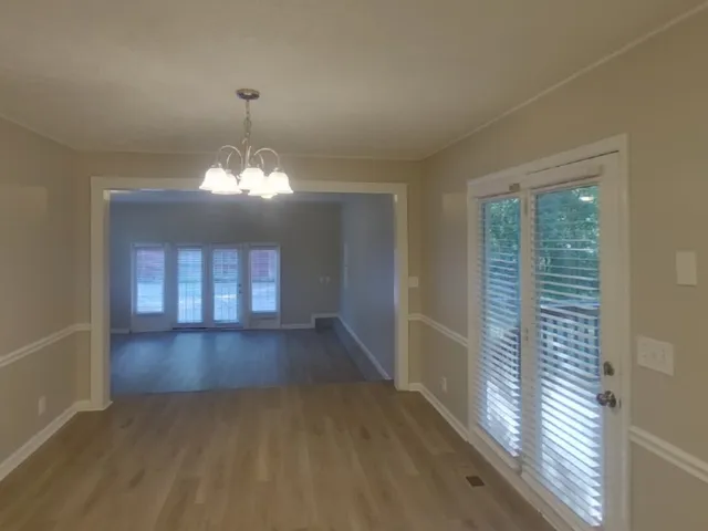 a view of a room with wooden floor and window