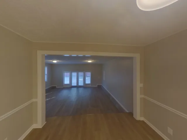 a large kitchen with a sink and refrigerator