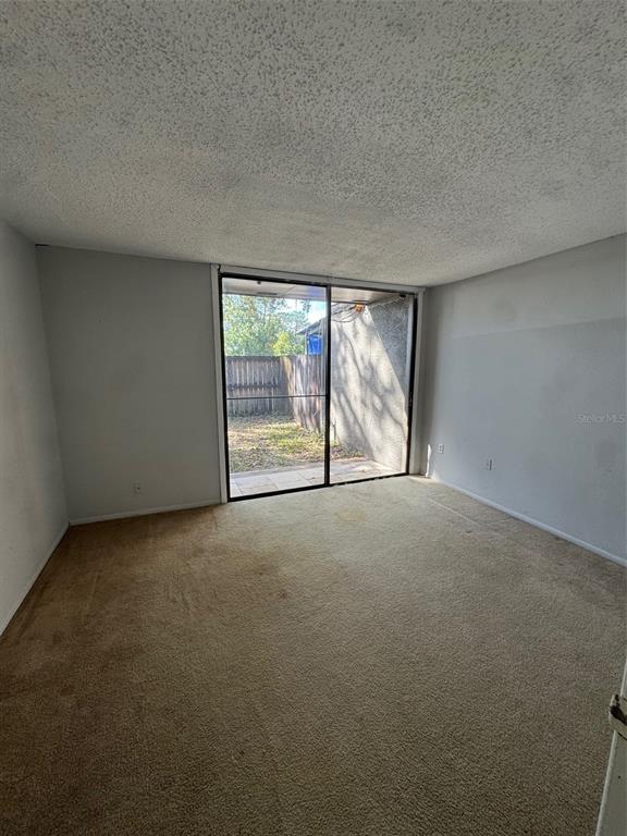 717 Southwest 75th Street, Unit 103 Gainesville, FL 32607 - Photo 11 of 13 an empty room with windows