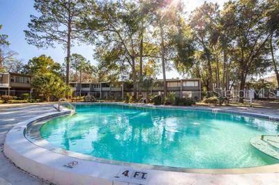 717 Southwest 75th Street, Unit 103 Gainesville, FL 32607 - Photo 13 of 13 a view of a swimming pool with a sitting area