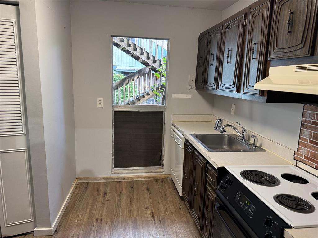 717 Southwest 75th Street, Unit 103 Gainesville, FL 32607 - Photo 3 of 13 a kitchen with stainless steel appliances a sink stove and cabinets