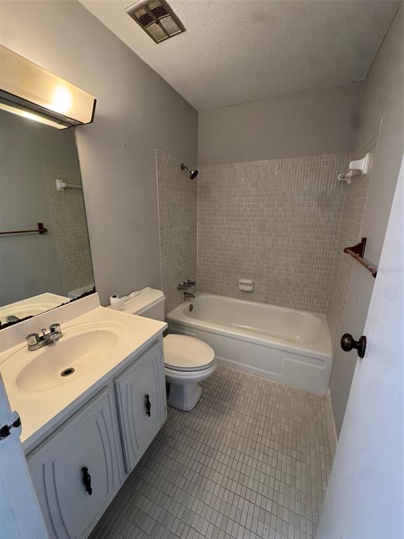 717 Southwest 75th Street, Unit 103 Gainesville, FL 32607 - Photo 6 of 13 a bathroom with a sink a toilet and shower