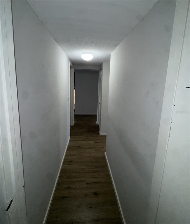 717 Southwest 75th Street, Unit 103 Gainesville, FL 32607 - Photo 8 of 13 a view of a hallway with the entryway