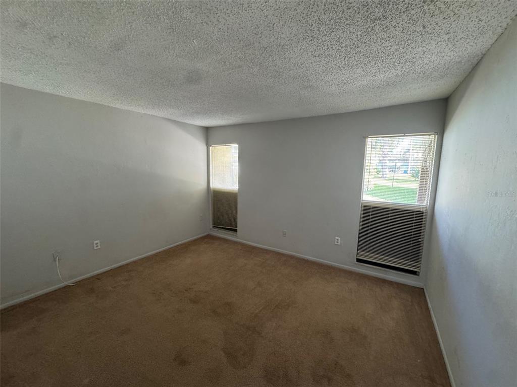 717 Southwest 75th Street, Unit 103 Gainesville, FL 32607 - Photo 9 of 13 an empty room with windows