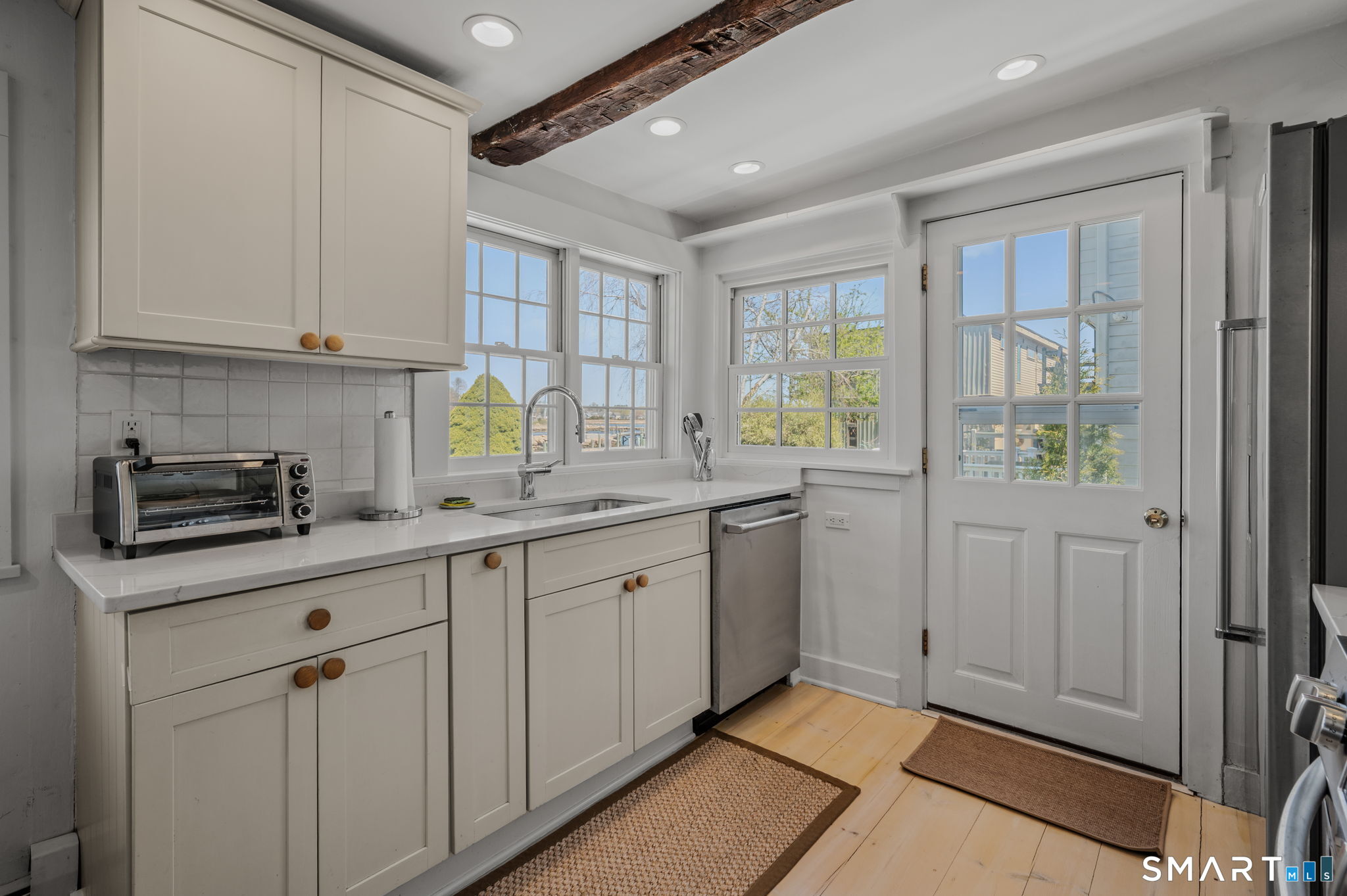 20 Diving Street Stonington, CT 06378 - Photo 14 of 33 a kitchen with granite countertop cabinets stainless steel appliances a sink and a window
