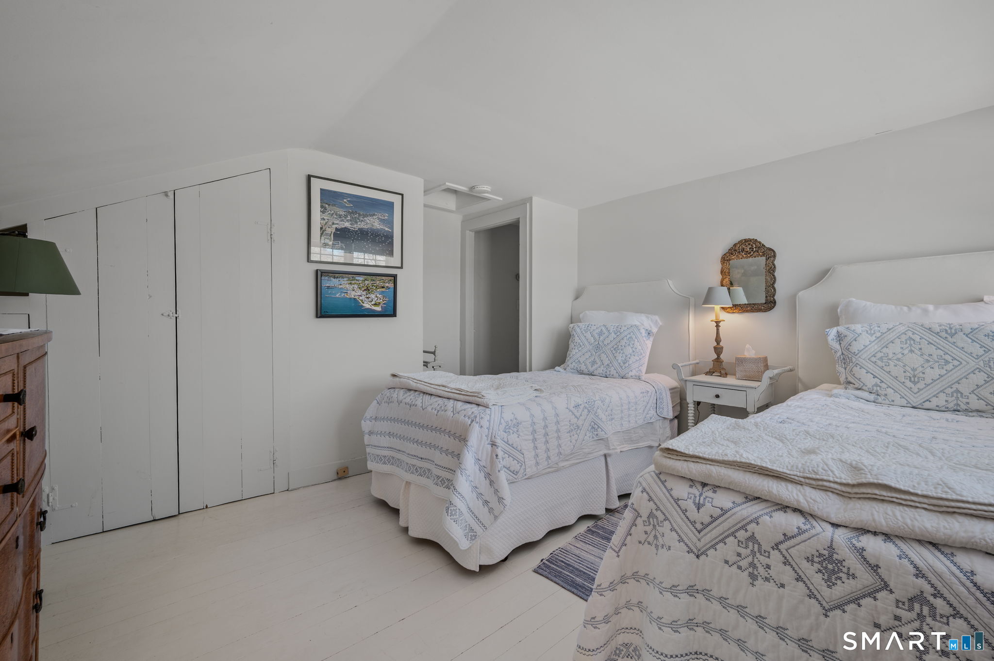 20 Diving Street Stonington, CT 06378 - Photo 22 of 33 a bedroom with a bed and a lamp