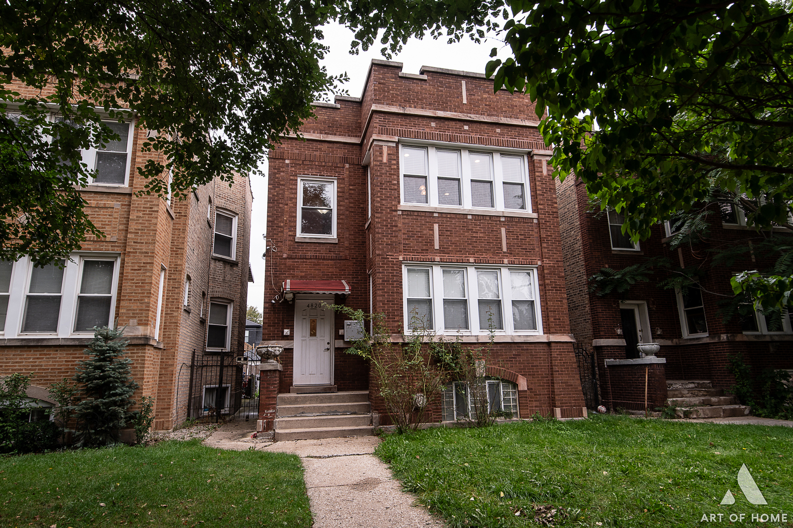 4820 West George Street, Unit 2 Chicago, IL 60641 - Photo 1 of 24 a front view of a house with garden