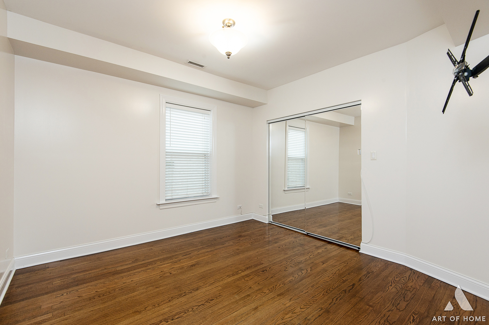 4820 West George Street, Unit 2 Chicago, IL 60641 - Photo 11 of 24 an empty room with wooden floor and windows