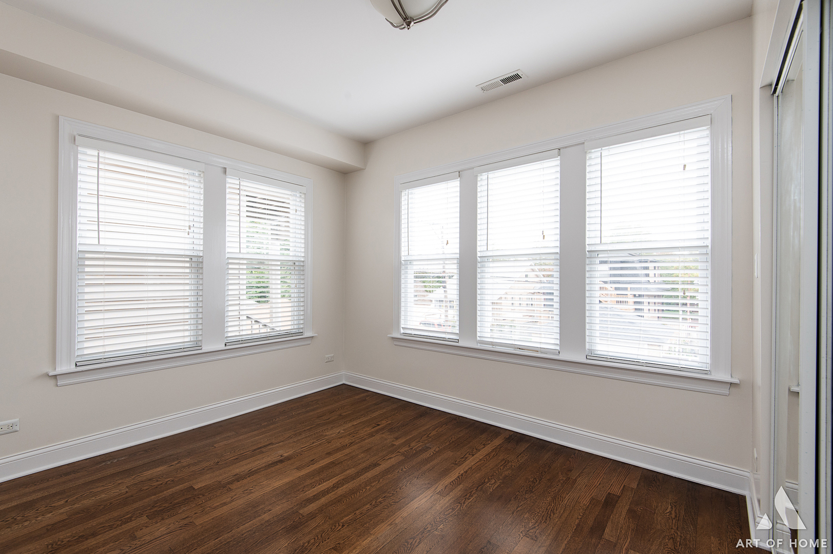 4820 West George Street, Unit 2 Chicago, IL 60641 - Photo 12 of 24 a view of an empty room with wooden floor and a window