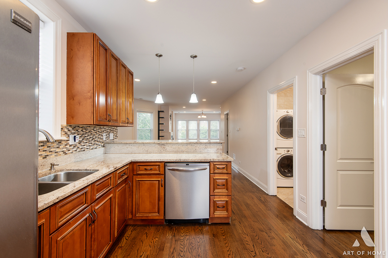 4820 West George Street, Unit 2 Chicago, IL 60641 - Photo 13 of 24 a kitchen with stainless steel appliances granite countertop wooden cabinets a sink and dishwasher