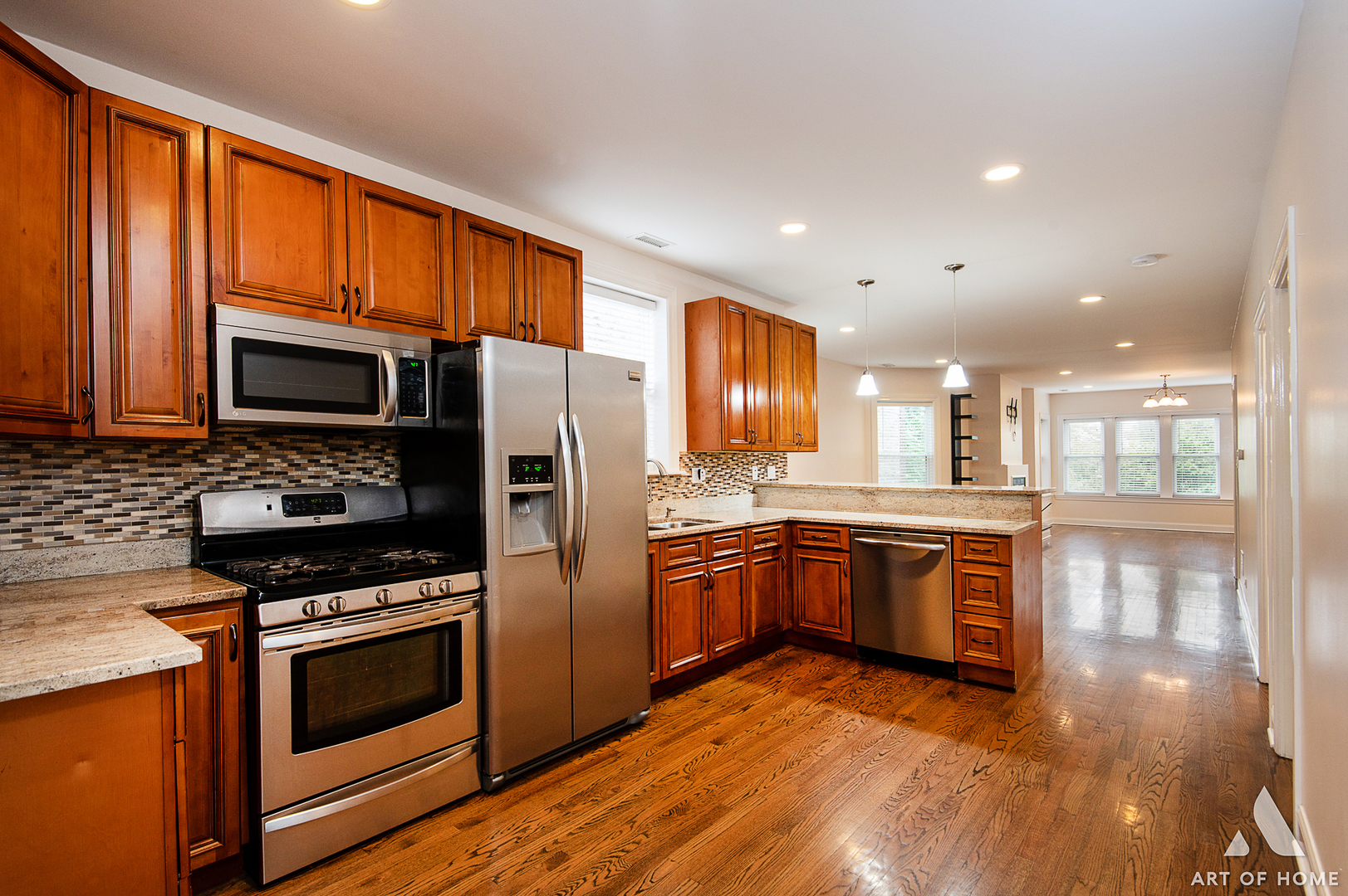 4820 West George Street, Unit 2 Chicago, IL 60641 - Photo 14 of 24 a kitchen with granite countertop stainless steel appliances and wooden cabinets