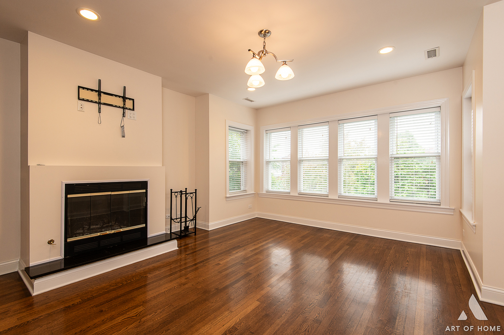 4820 West George Street, Unit 2 Chicago, IL 60641 - Photo 2 of 24 a view of an empty room with wooden floor fireplace and a window