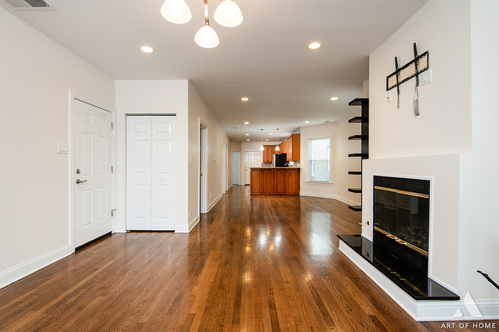 4820 West George Street, Unit 2 Chicago, IL 60641 - Photo 22 of 24 a living room with stainless steel appliances furniture a fireplace and wooden floor