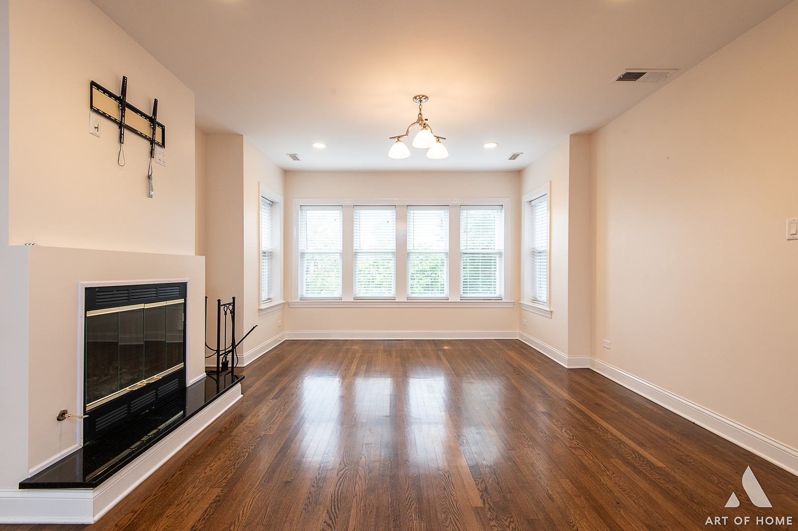 4820 West George Street, Unit 2 Chicago, IL 60641 - Photo 23 of 24 a view of an empty room with wooden floor fireplace and a window